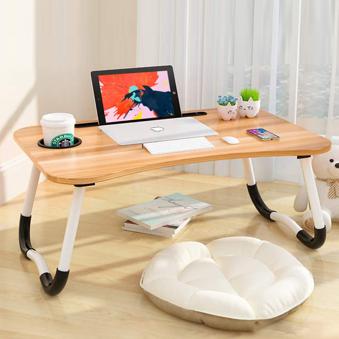Foldable table with cup holder and tablet holder. Light brown surface with white legs. For beds and sofas